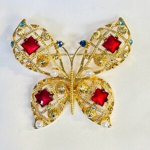 Brooch, Butterfly, NIP, on gold tone base w/ red rhinestones, 2.25” x 2.5”
